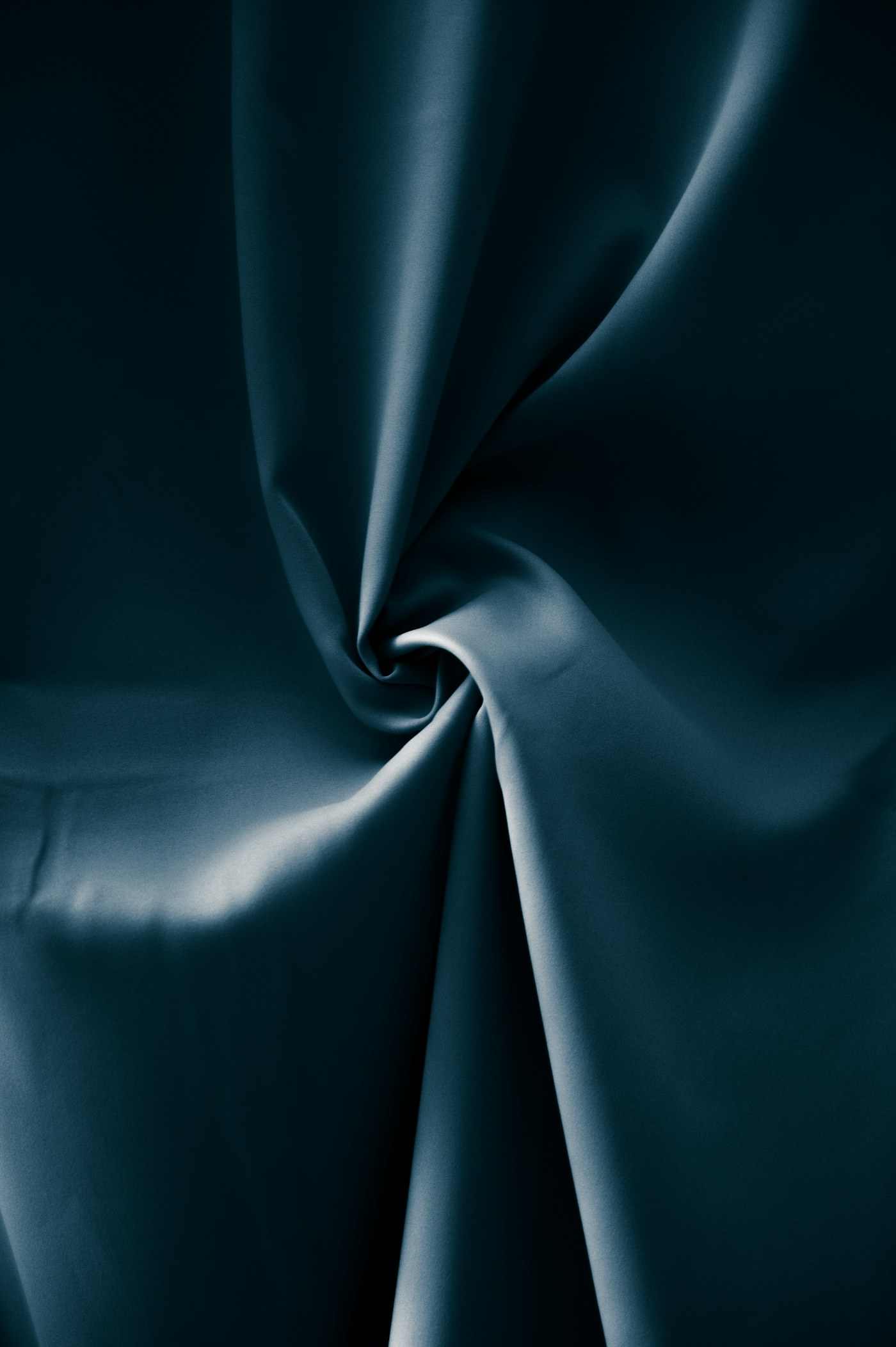 Deep blue fabric folded into soft shapes